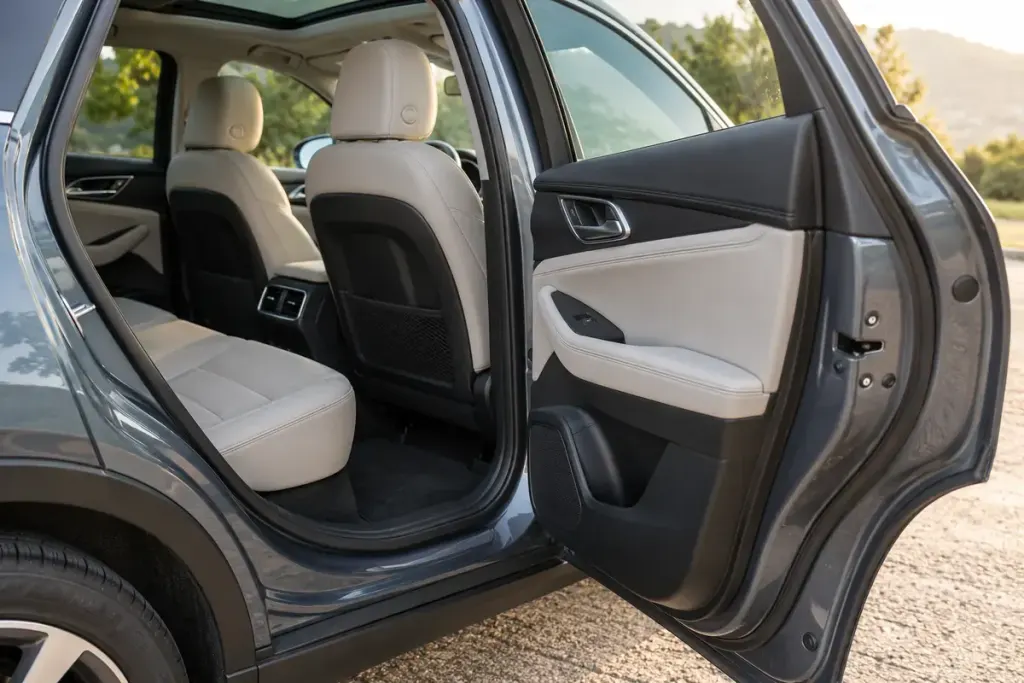 The open rear passenger door of a parked car.